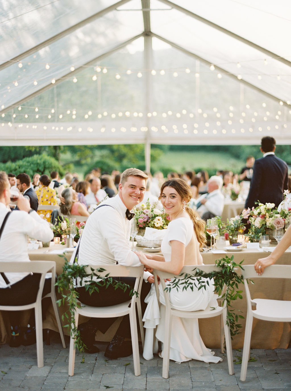 Bride and Groom at Head Table in Outdoor Tented Reception for Southern Garden Wedding