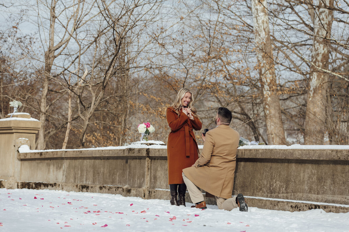 Winter Proposal | Groom-to-be proposing at Natirar Park surrounded by snow-covered scenery | Peapack-Gladstone, New Jersey