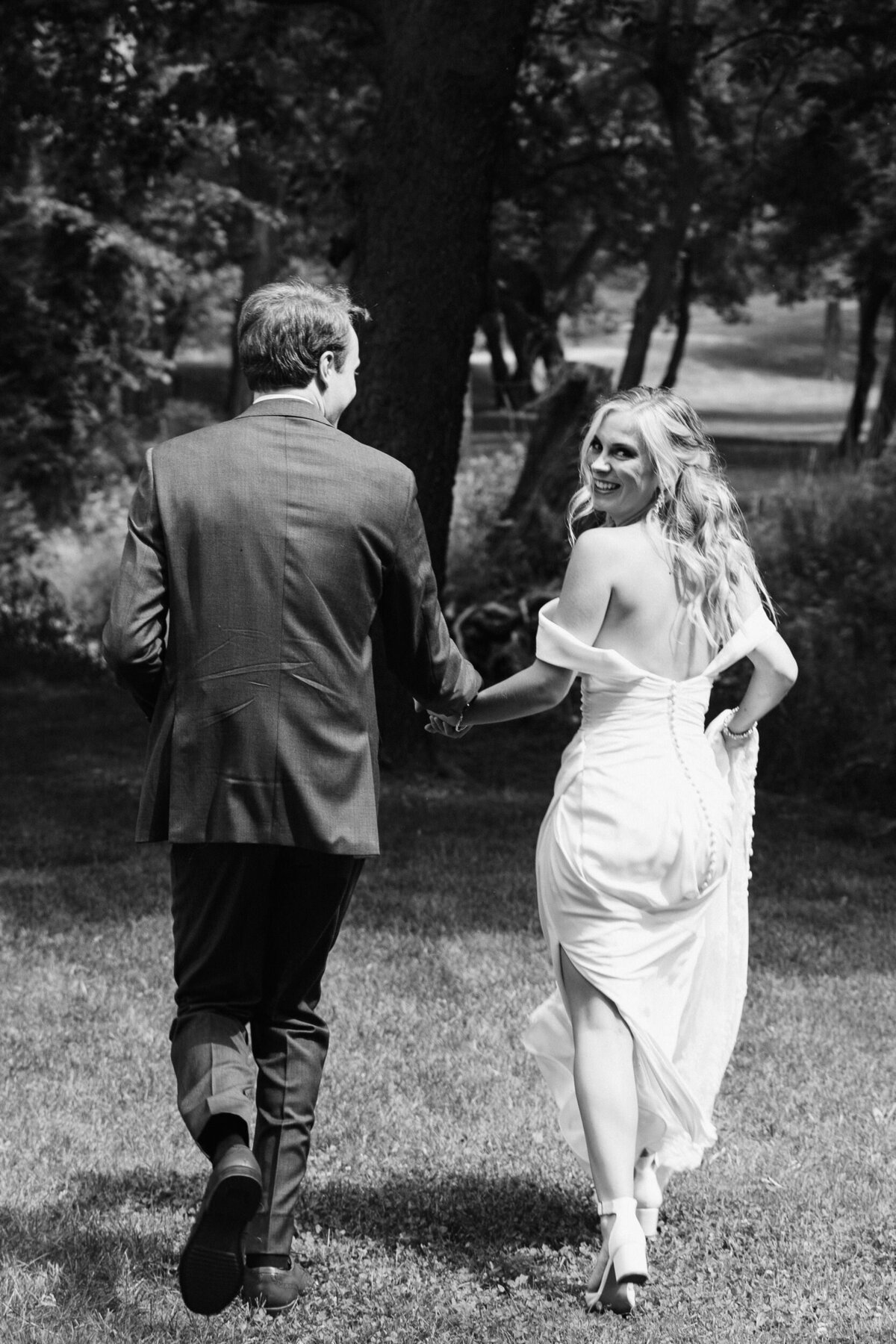 A couple holding hands and running away together