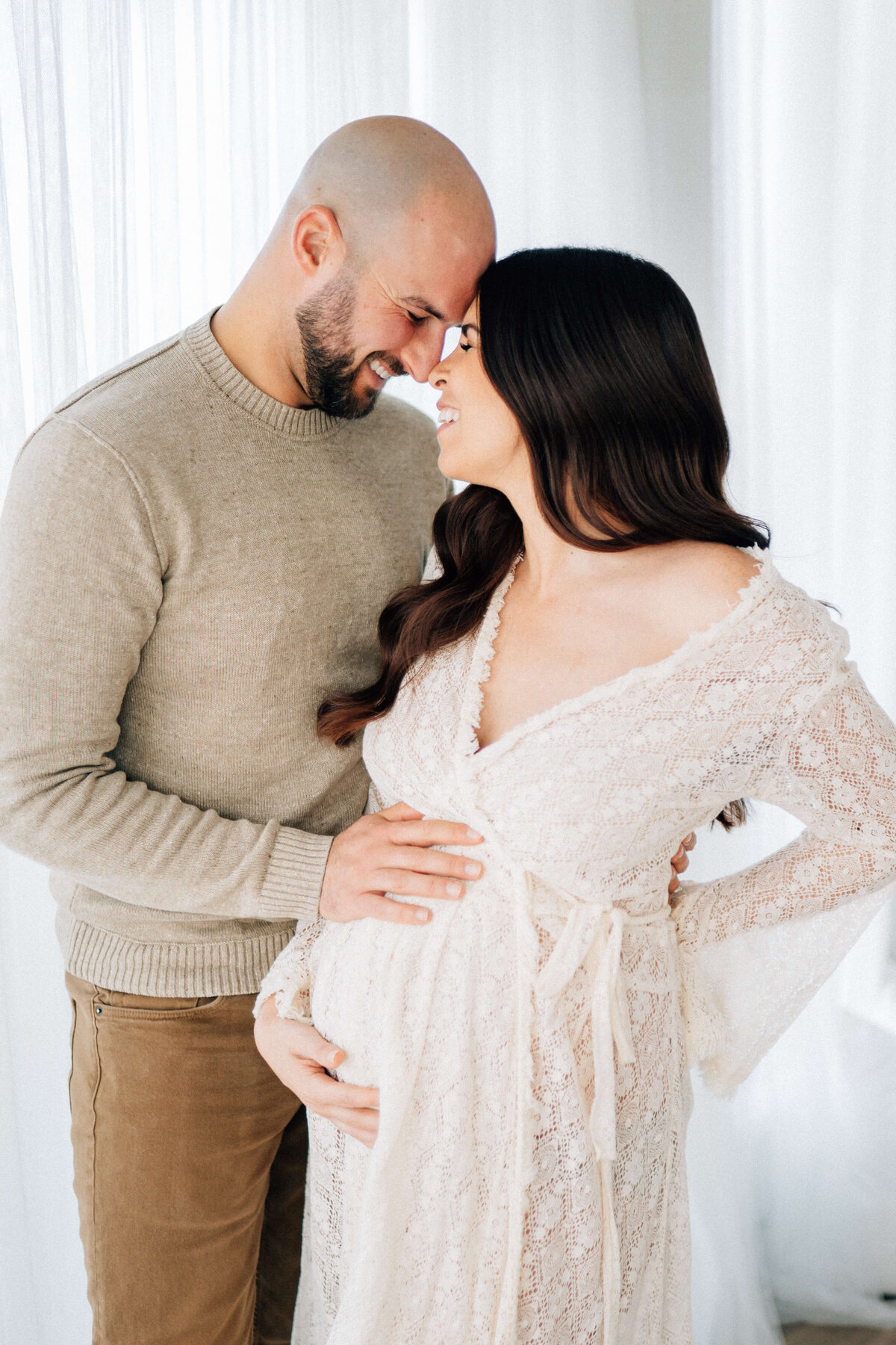 maternity mother and father looking into each other eyes