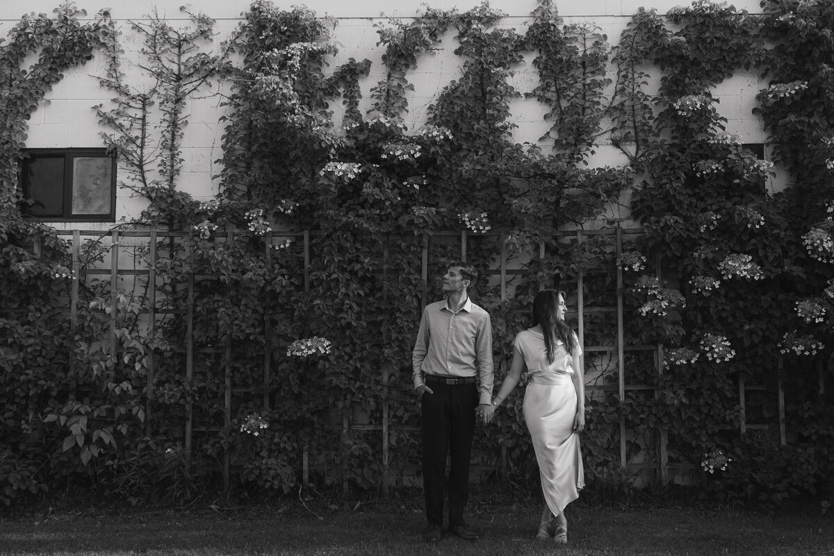 black and white photo of bride and groom touching noses
