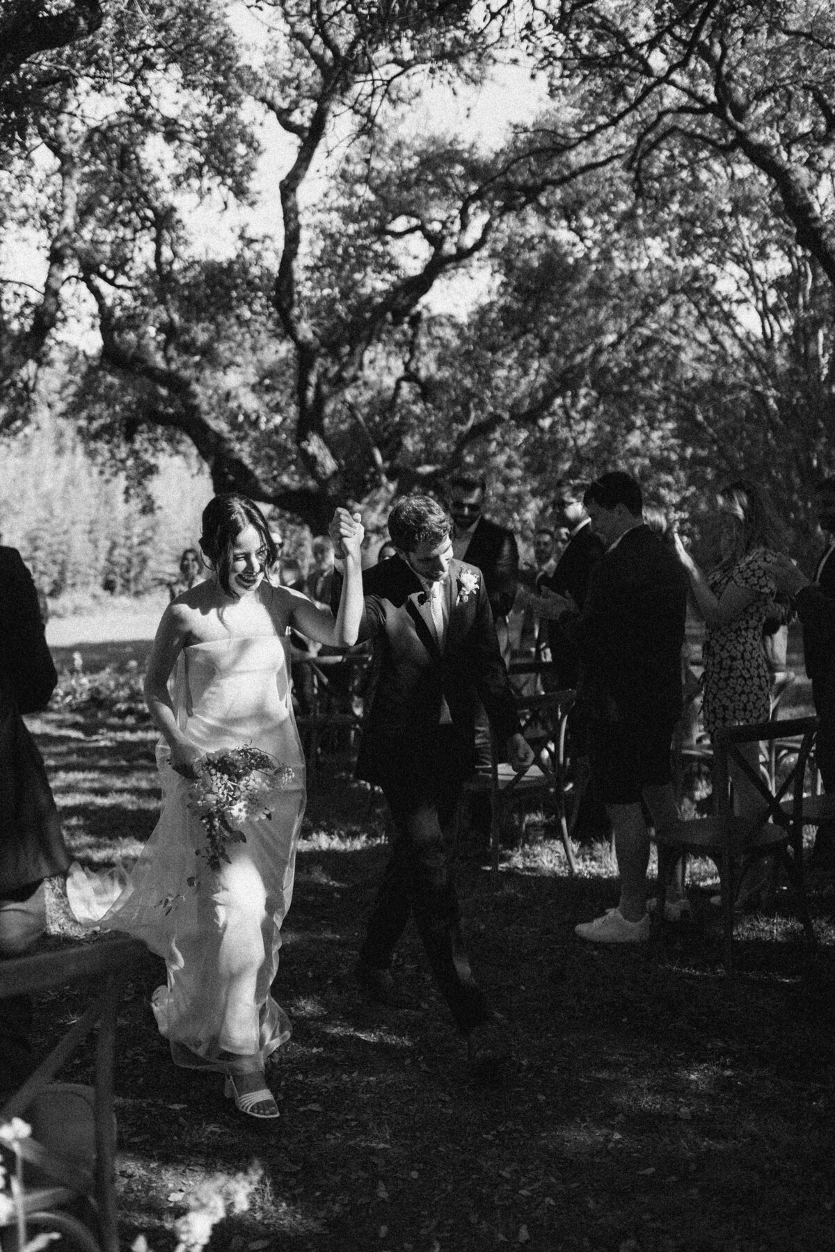 Bride and groom walking down the aisle after outdoor wedding ceremony at  Mattie's Austin