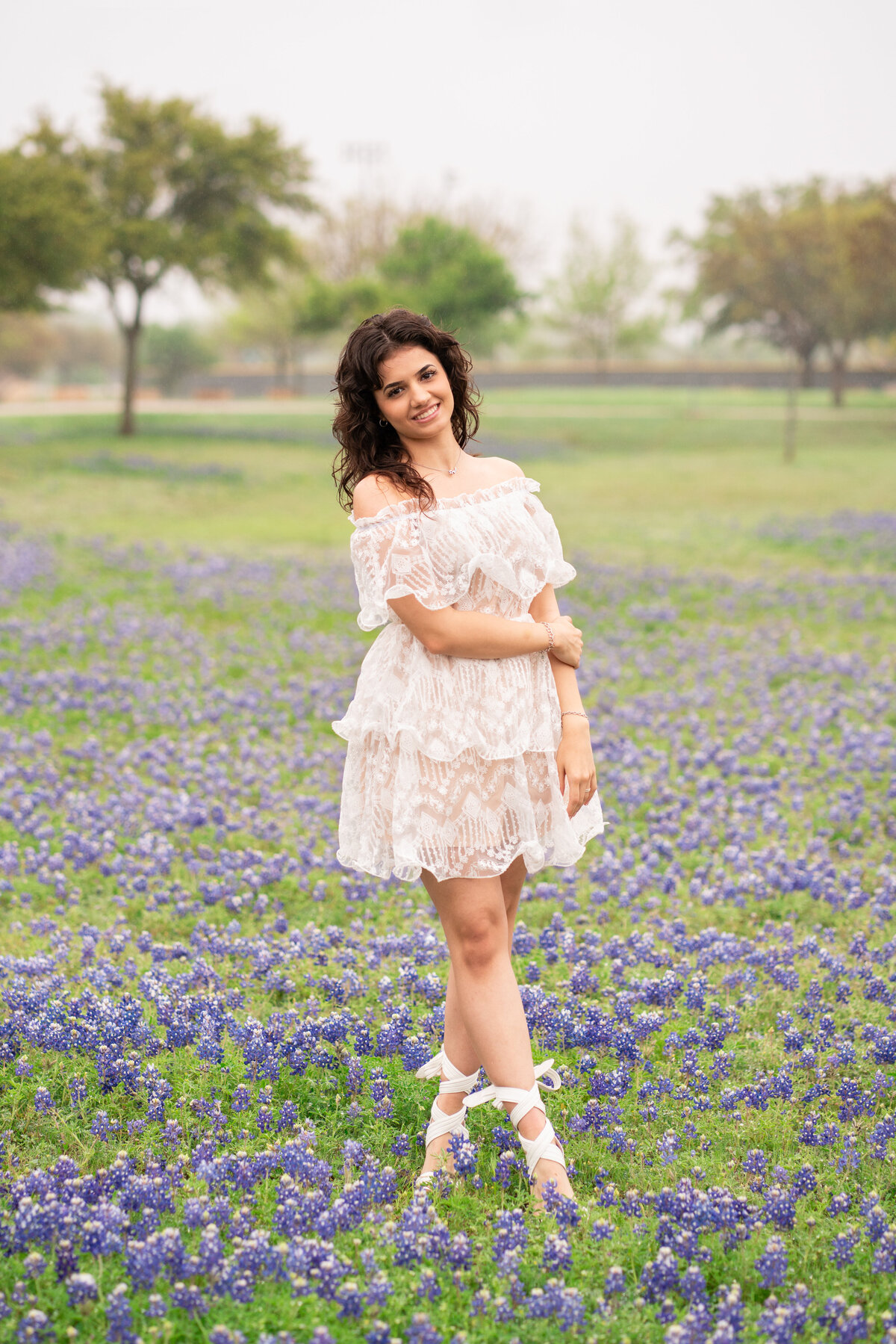 High school senior girl wearing a white dress in Austin Texas.