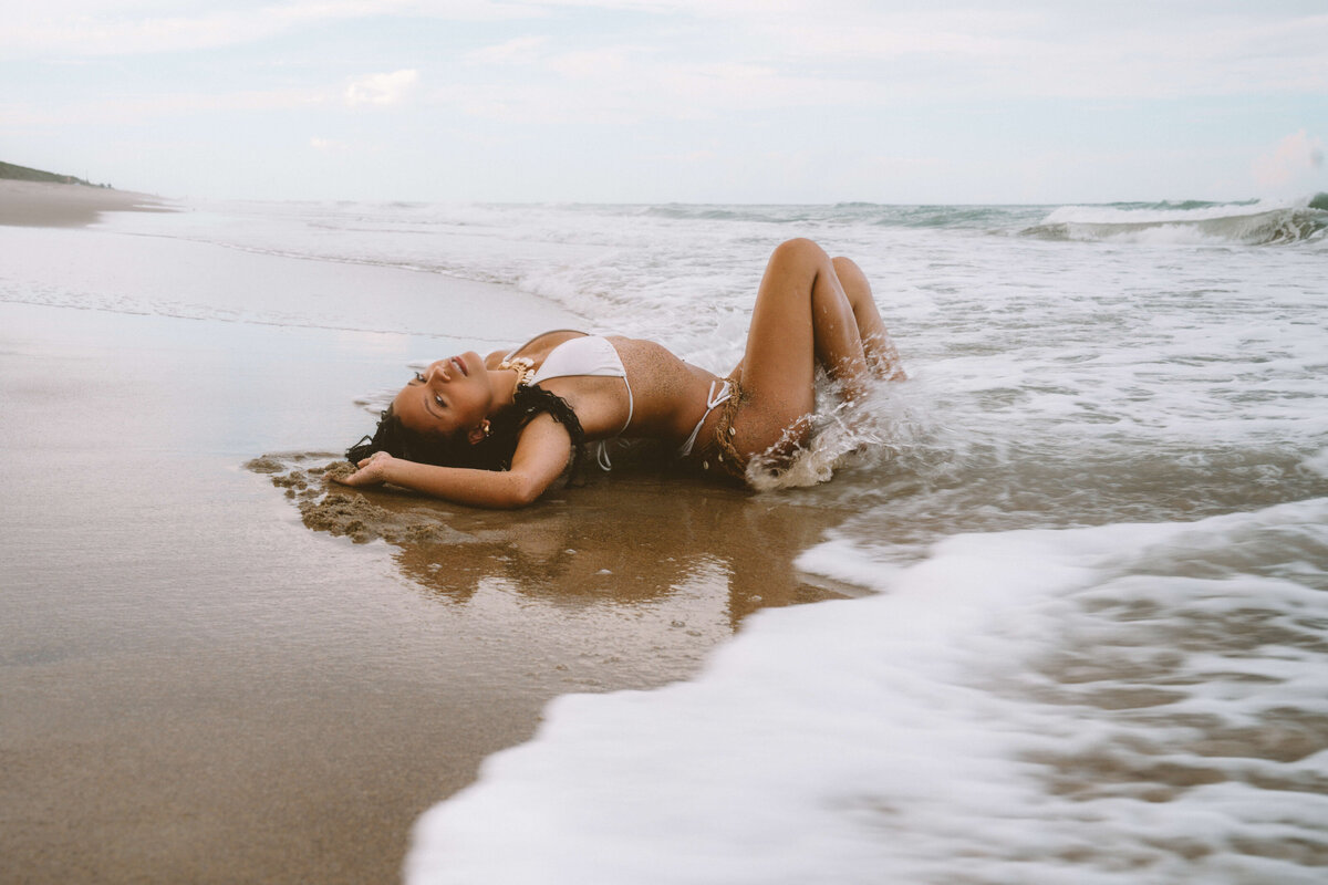 Model laying on beach