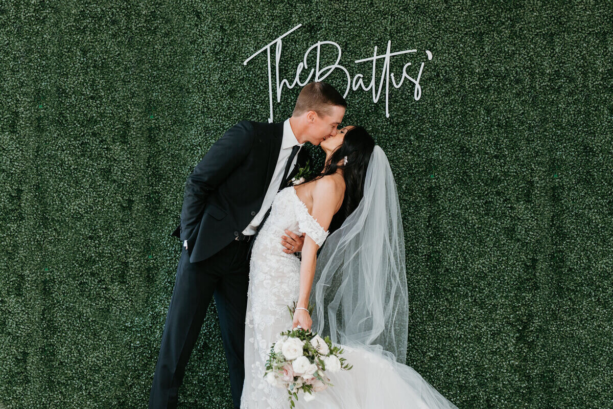 Bride and groom kissing at wedding by wedding planners in chicago