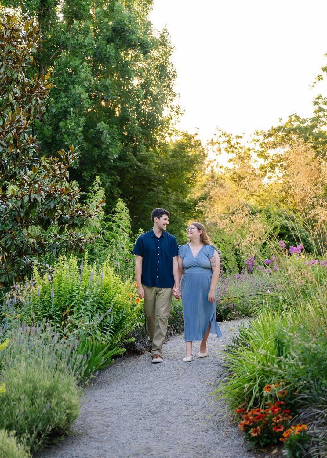couple walk along path in bellevue botanical garden