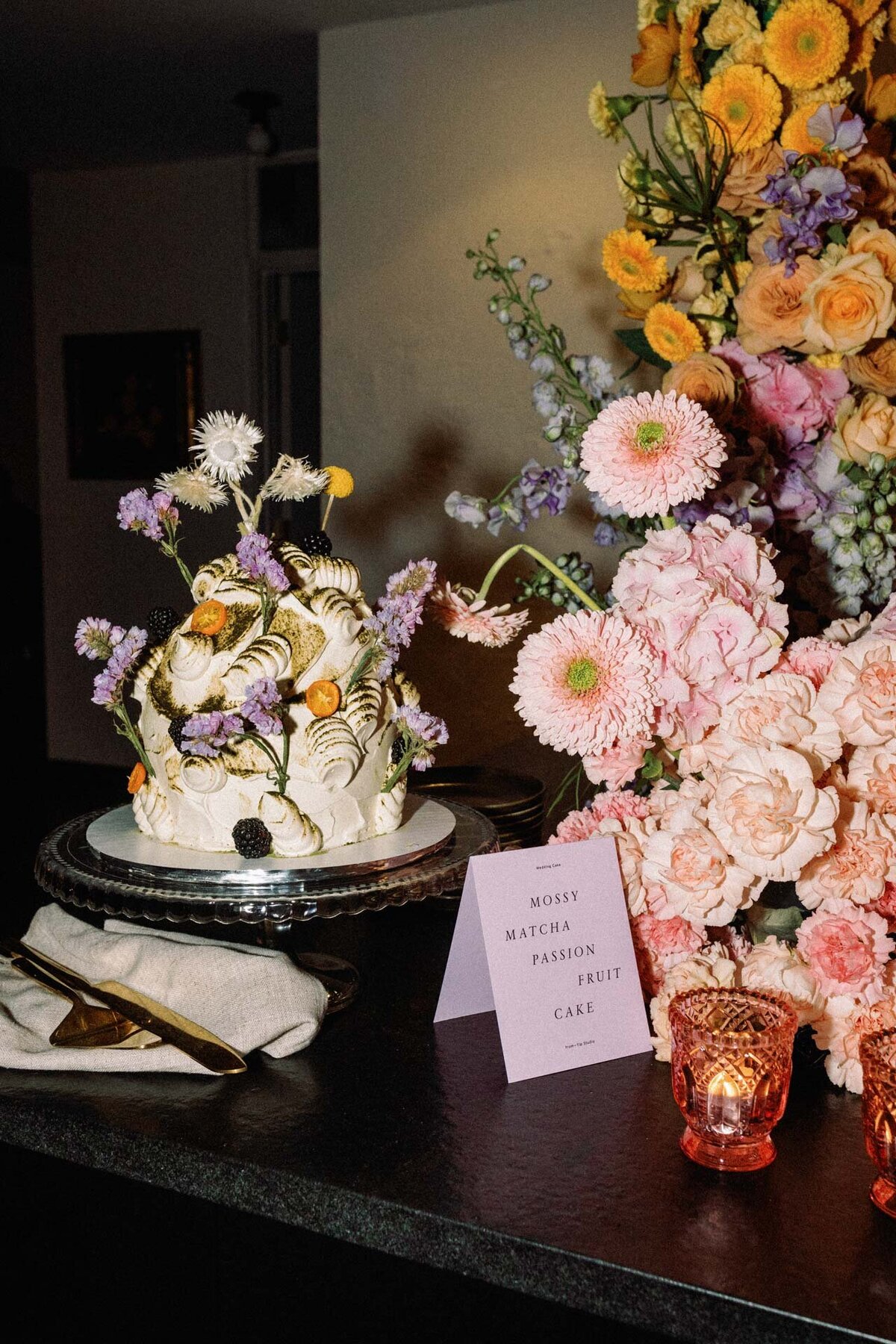 yip studio mossy matcha passionfruit cake with floral installation by little sister creative and signage by goods gang