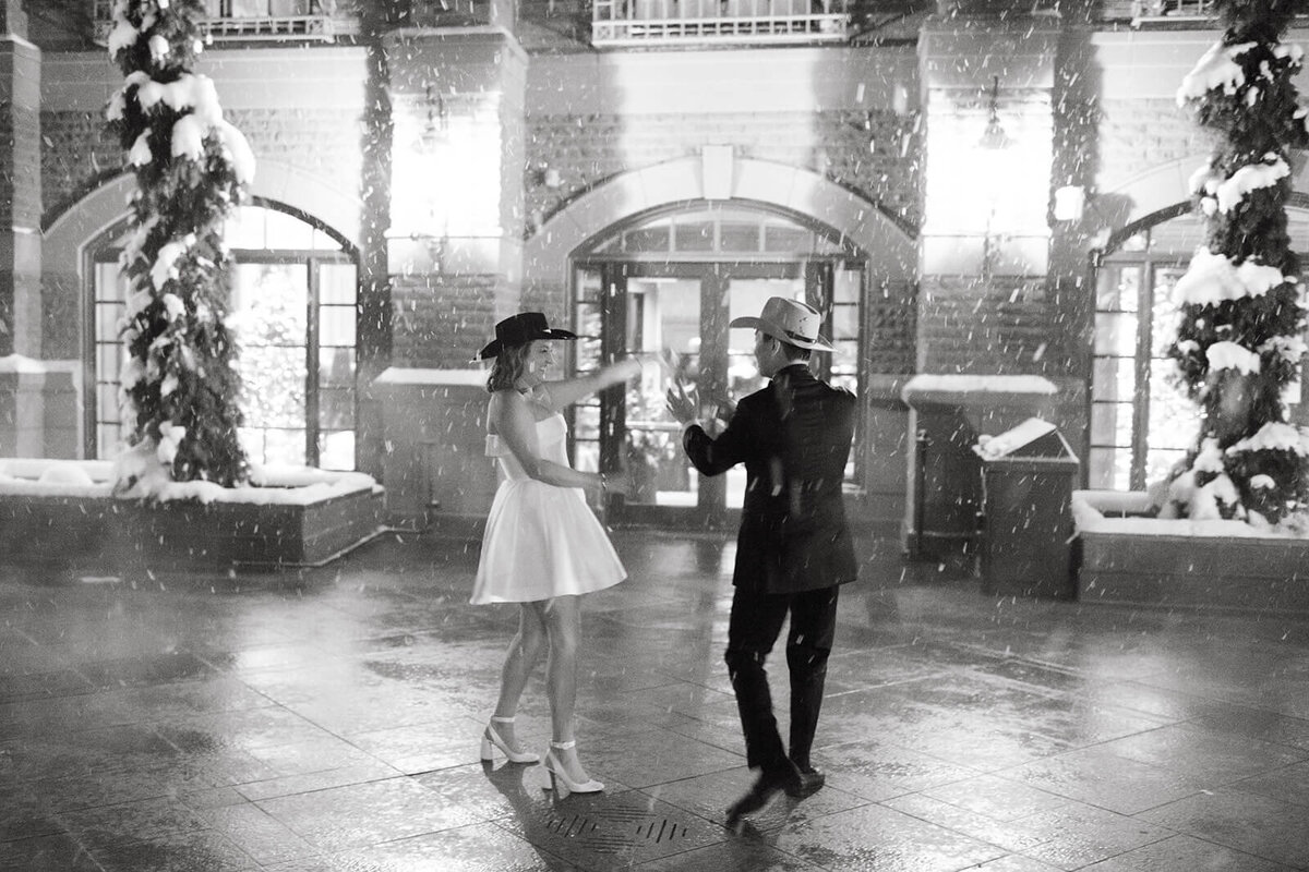 Bride and Groom share an intimate dance during the snow outside of the St. Regis Aspen wedding venue.