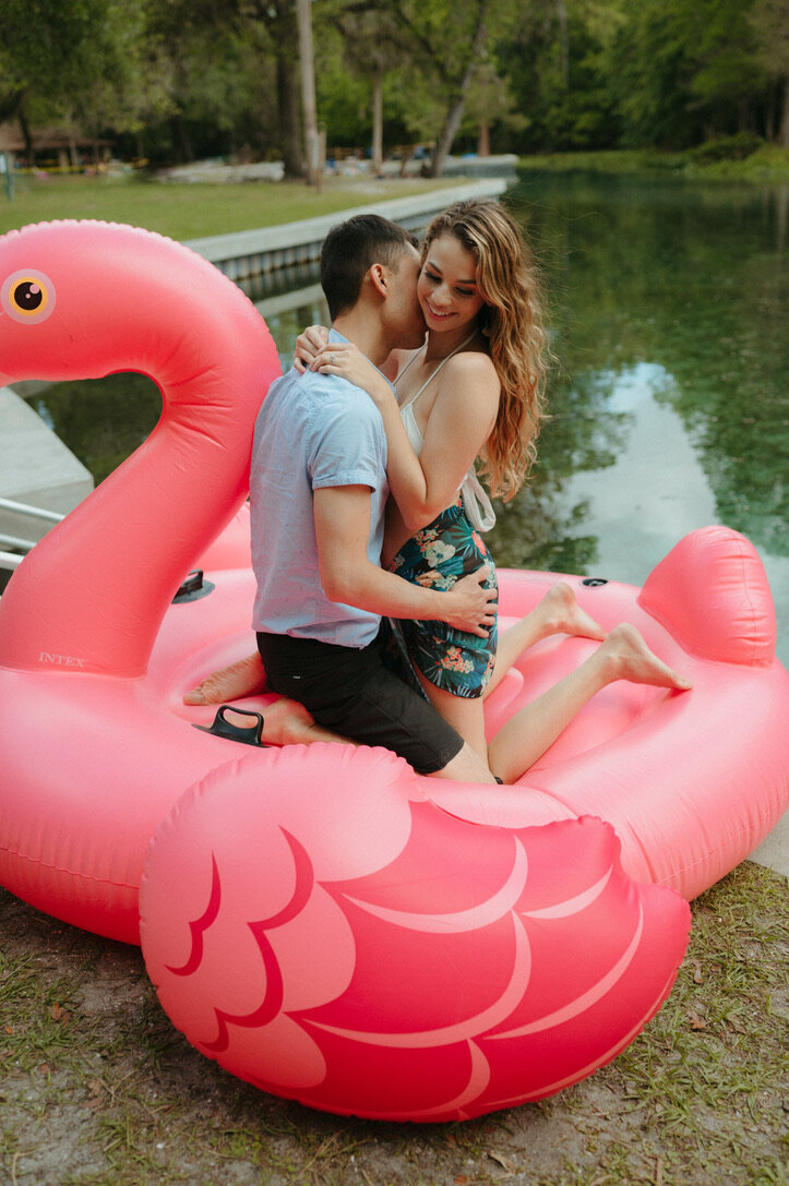 couple in inflatable floaty during engagement