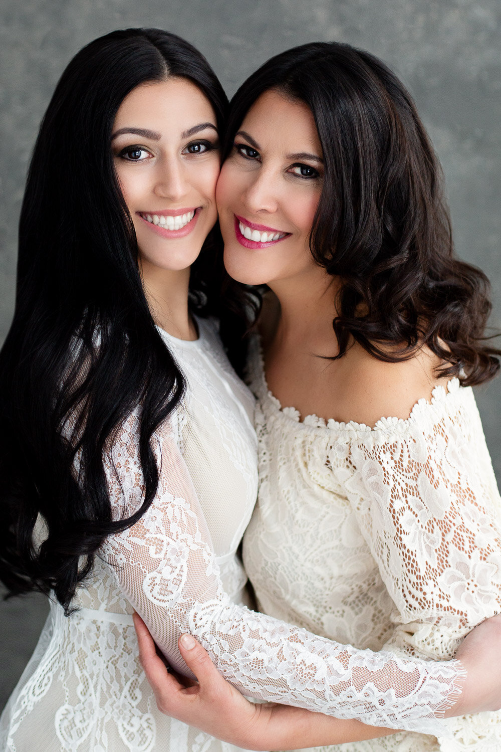 Beauty portrait of mother and daughter in matching dresses