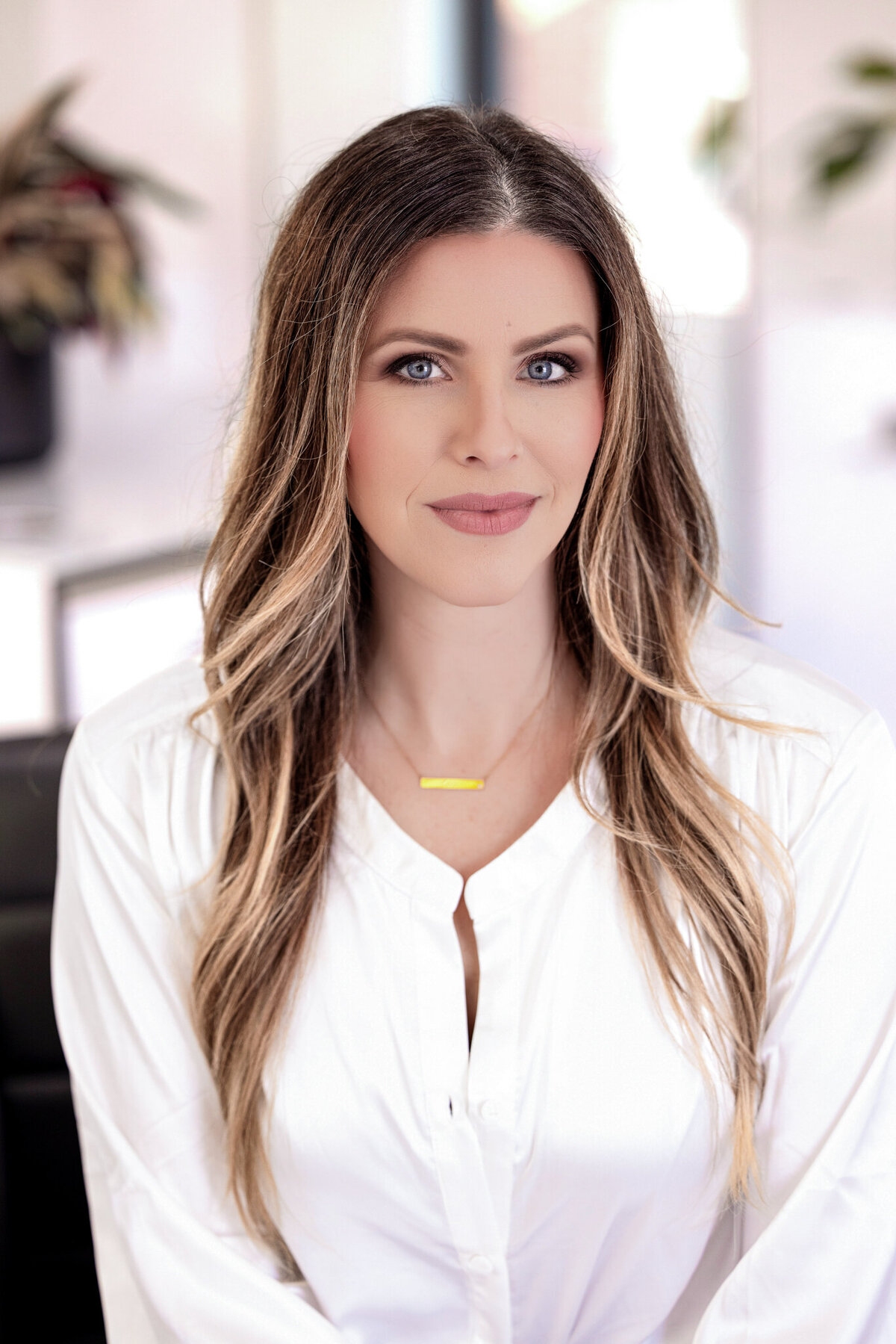 A confident, stylish portrait of a salon professional, embodying modern elegance in the beauty industry.