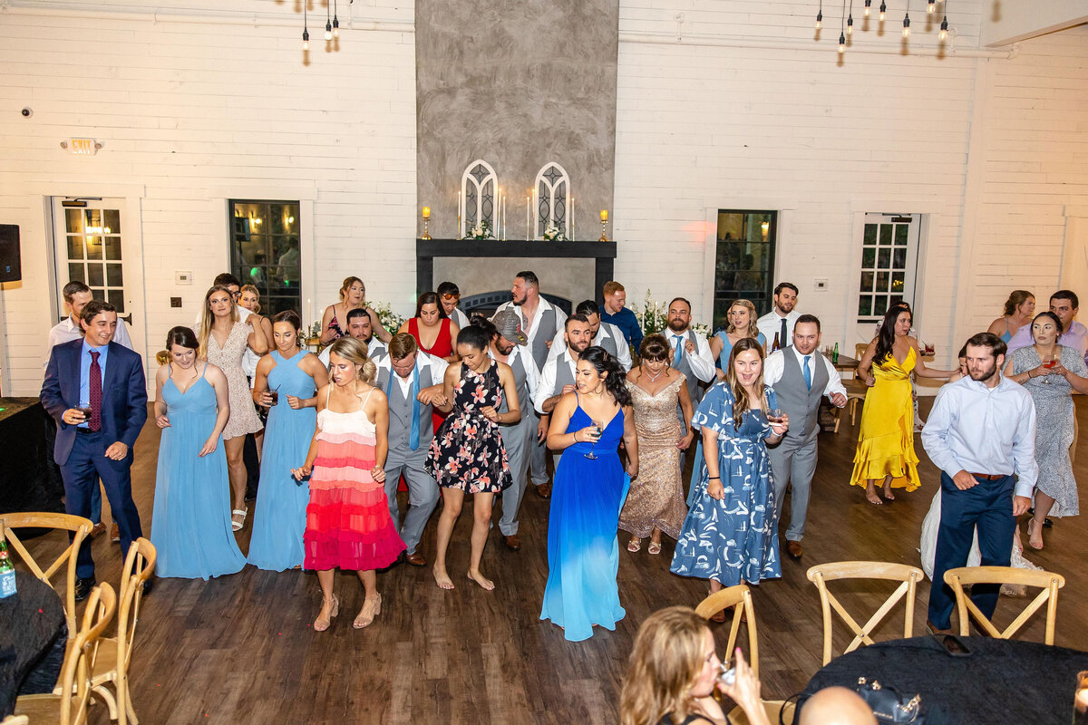 line dancing at Morgan Creek Barn wedding guests in vivid colors