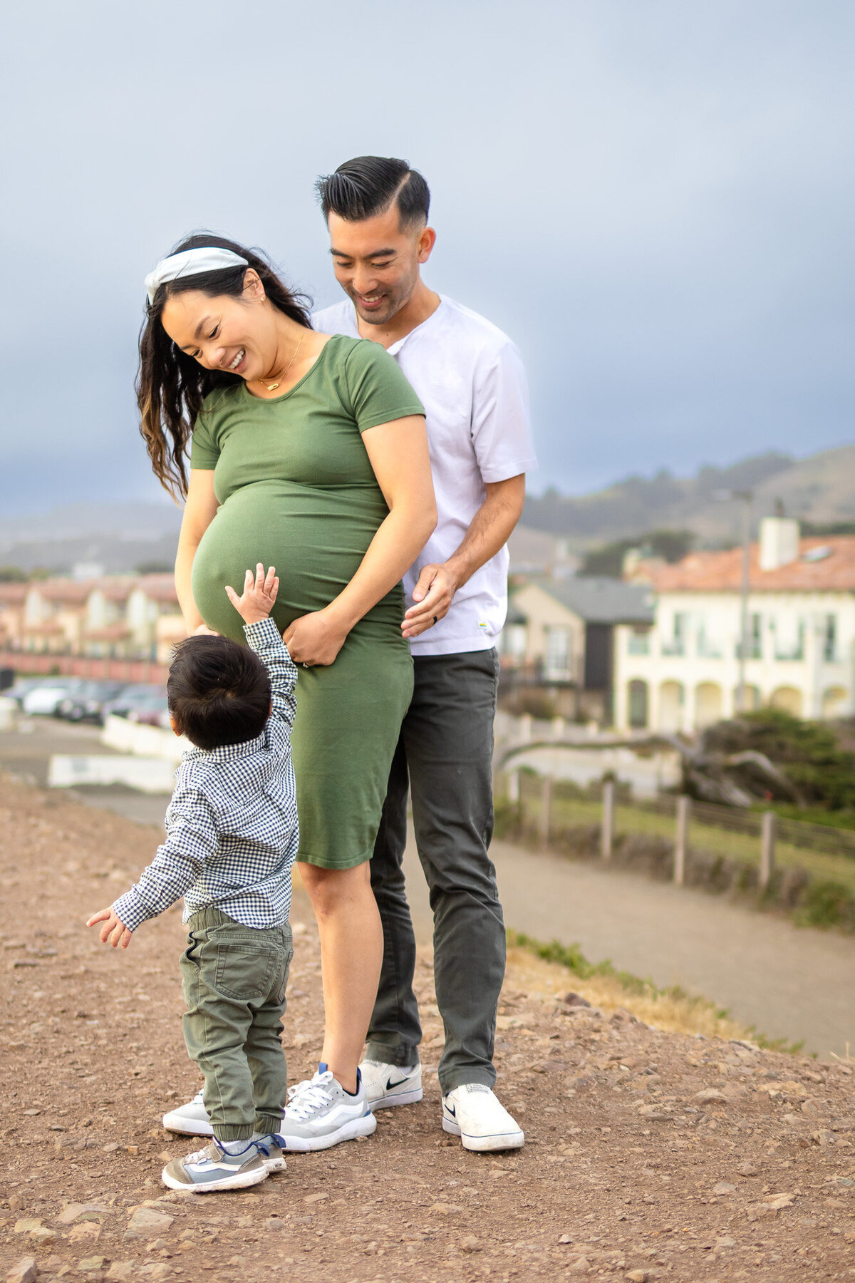 Expecting couple standing by the rocks with water and sunset in the background — Bay Area Maternity Portfolio - Ellobelle Photography Family Photographer