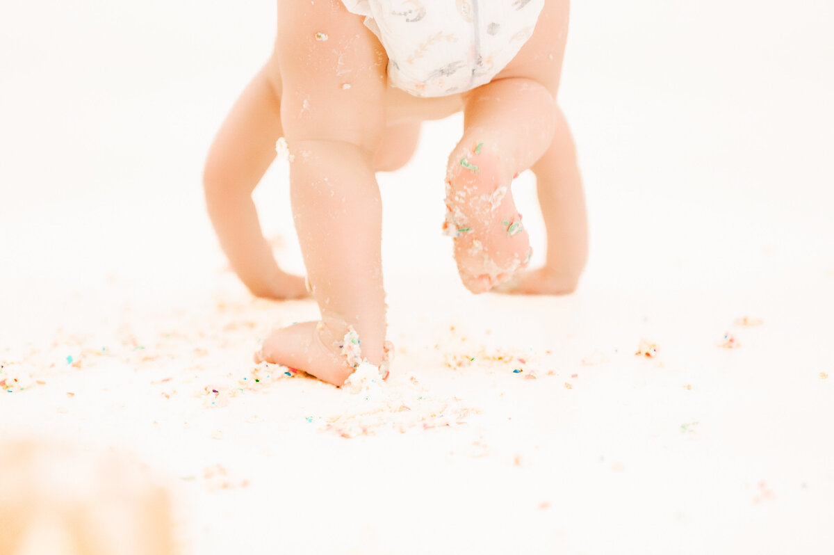 Springfield MO kids photography of close up of kid walking on crumbs of cake
