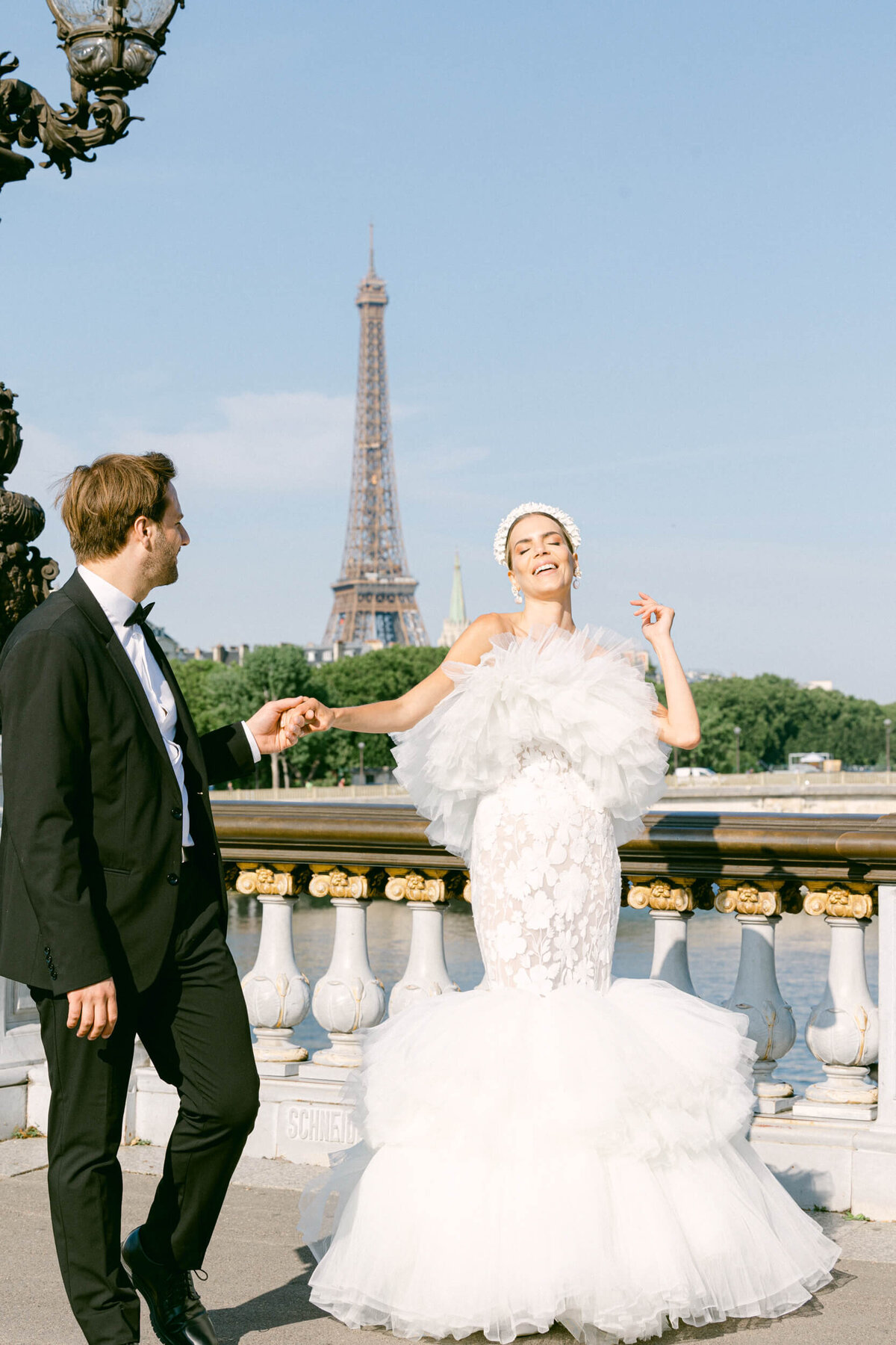 A wedding photo of a bride in her white dress in the streets of Paris in France.