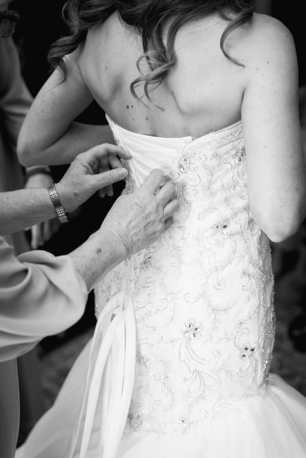 Black and white photo of bride getting ready