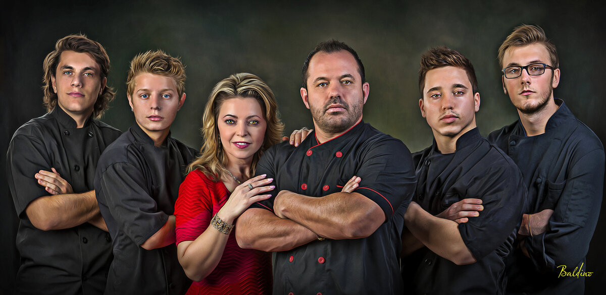 top chef with staff posing