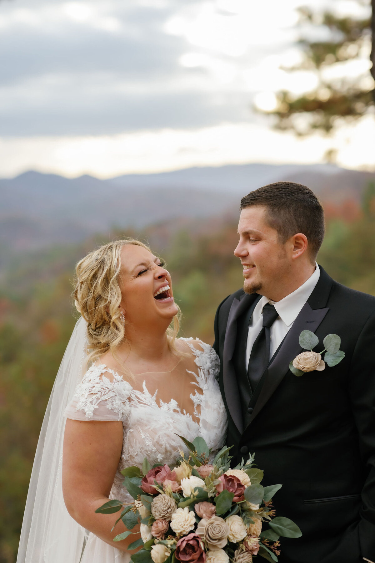 bride laughing while her groom smiles during their Gatlinburg elopement