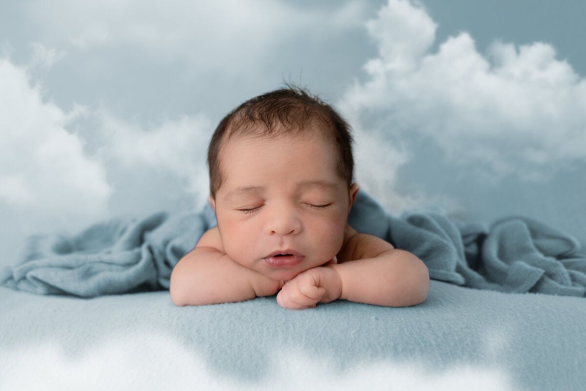Edmonton Newborn Photography baby in clouds blue backdrop