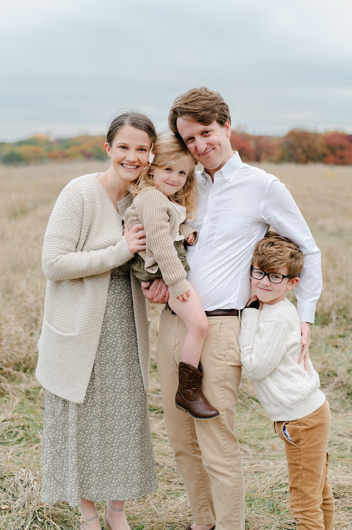 Family of four smiling at the camera, taken by Abby Park Photography in Milwaukee, Wisconsin