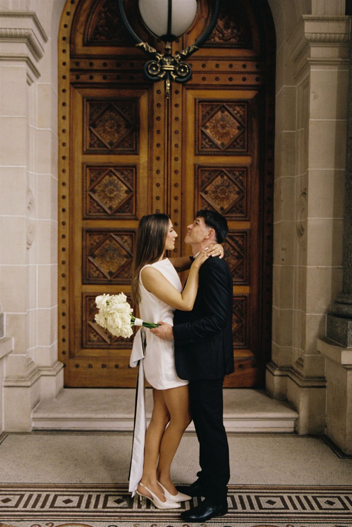 couple in front of parliament doors melbourne on 35mm film