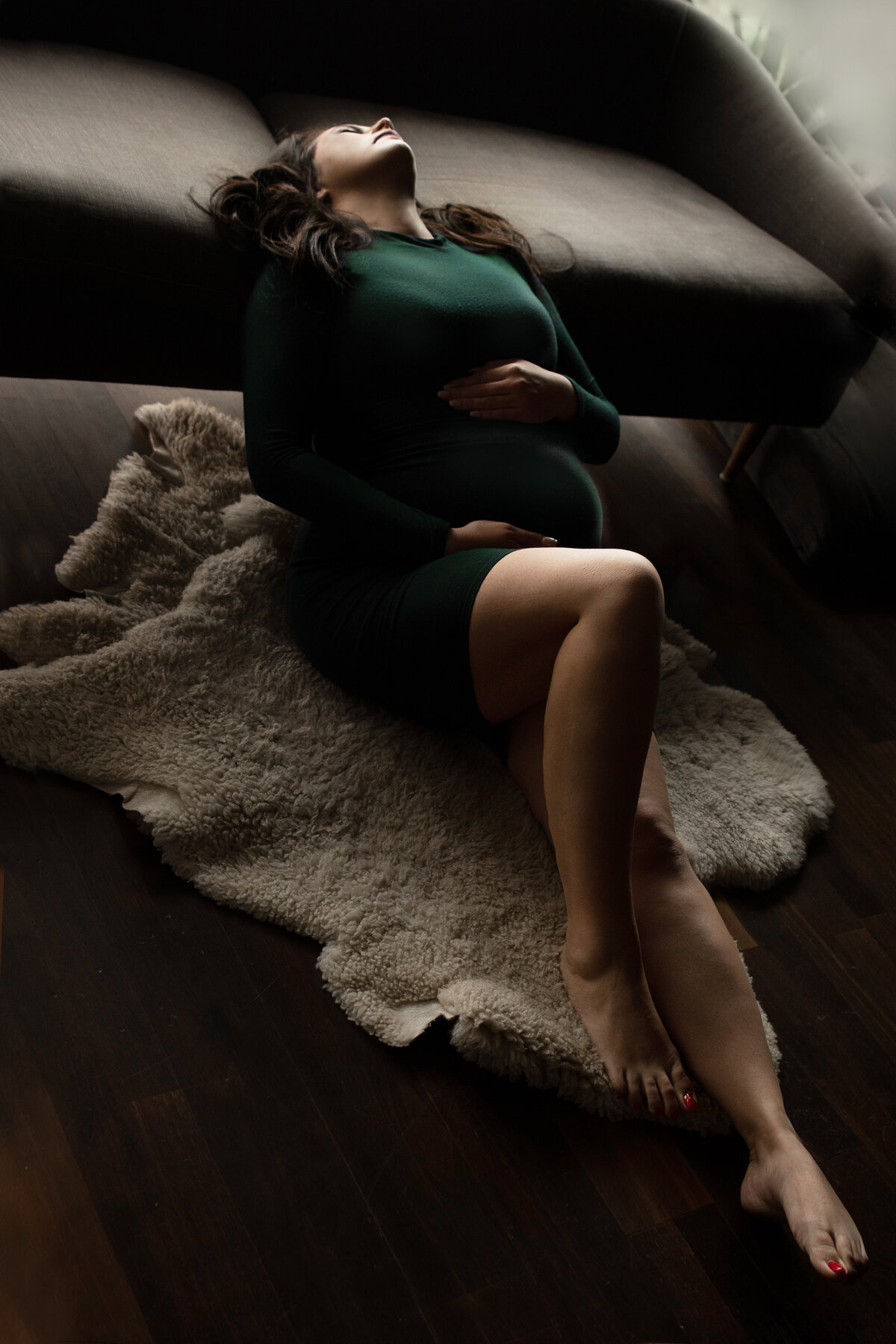 boudoir photo with pregnant woman holding belly
