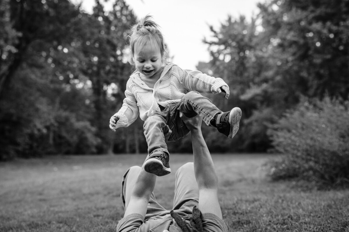 A kid is thrown in the air, laughing.