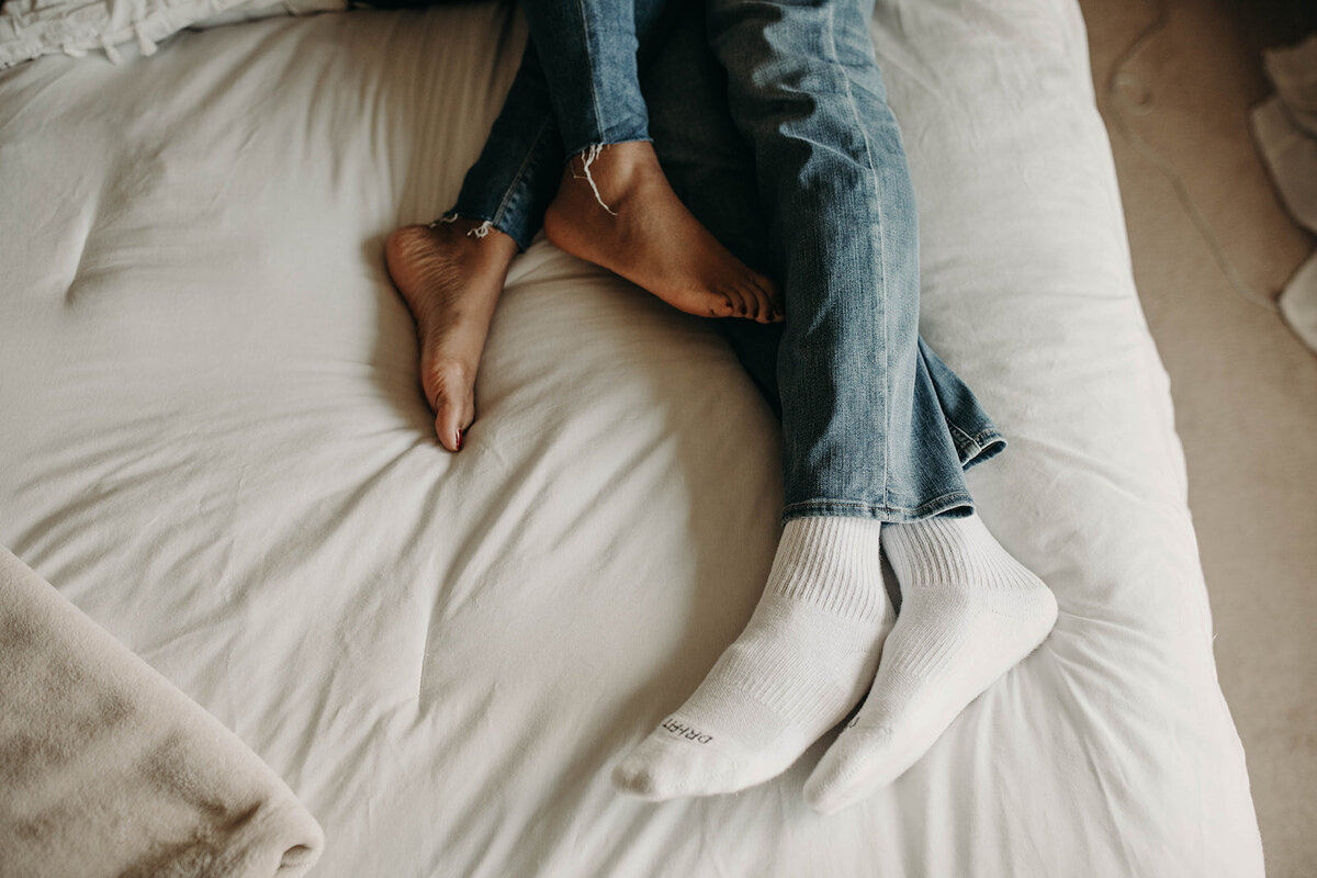 Feet on a bed.