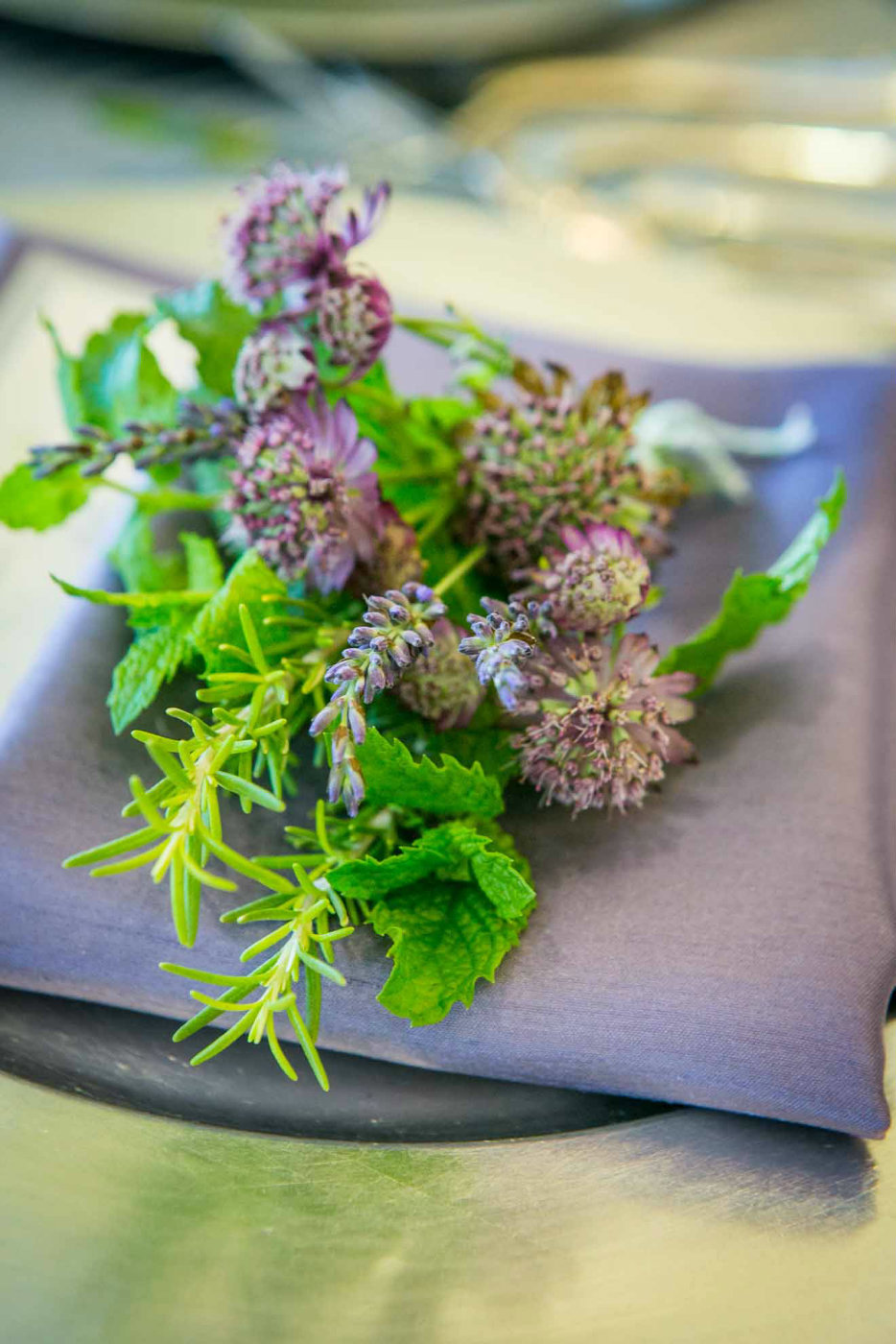 bunch of herbs as napkin treatment on purple napkin