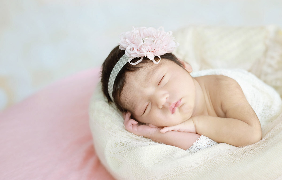Newborn baby girl sleeping on the side during her home photo session in Calgary Alberta