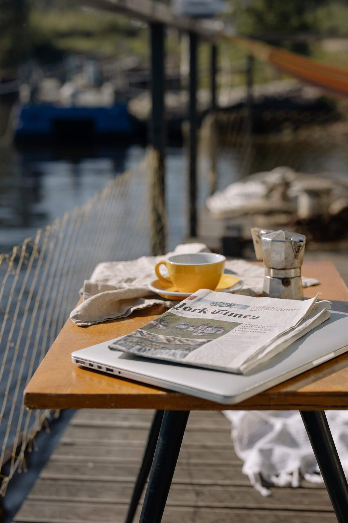 Coffee and newspaper by the lake