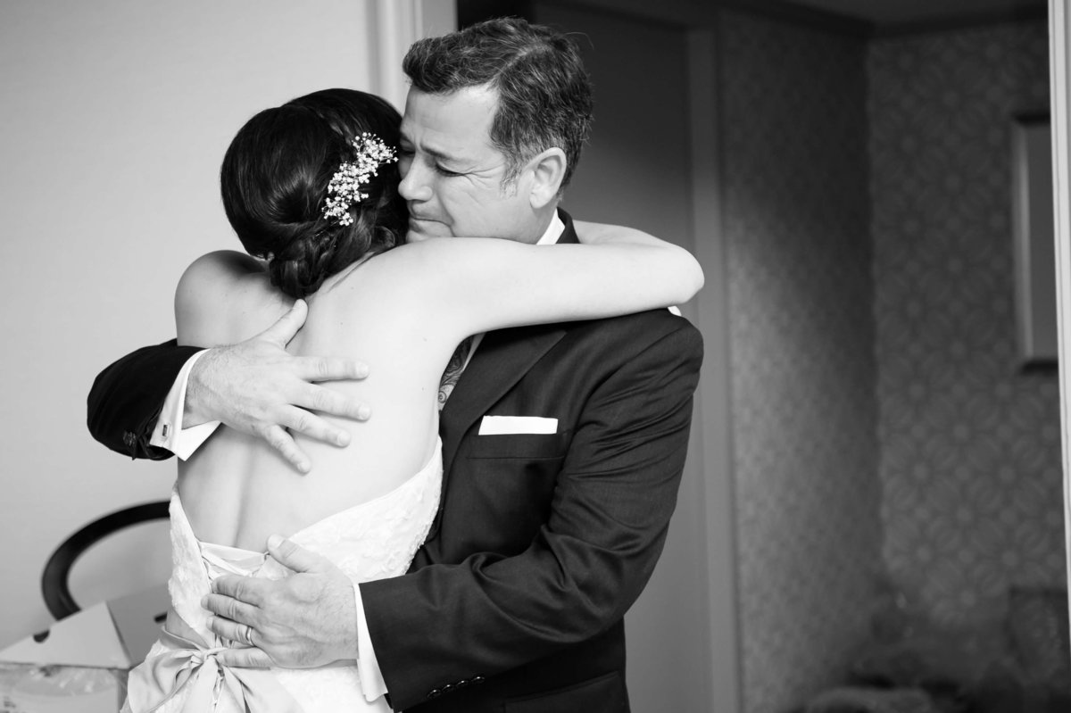 Bride shares a tender hug with her Dad as he sees her for the first time on her Wedding day at the Grand Hyatt Tampa Bay