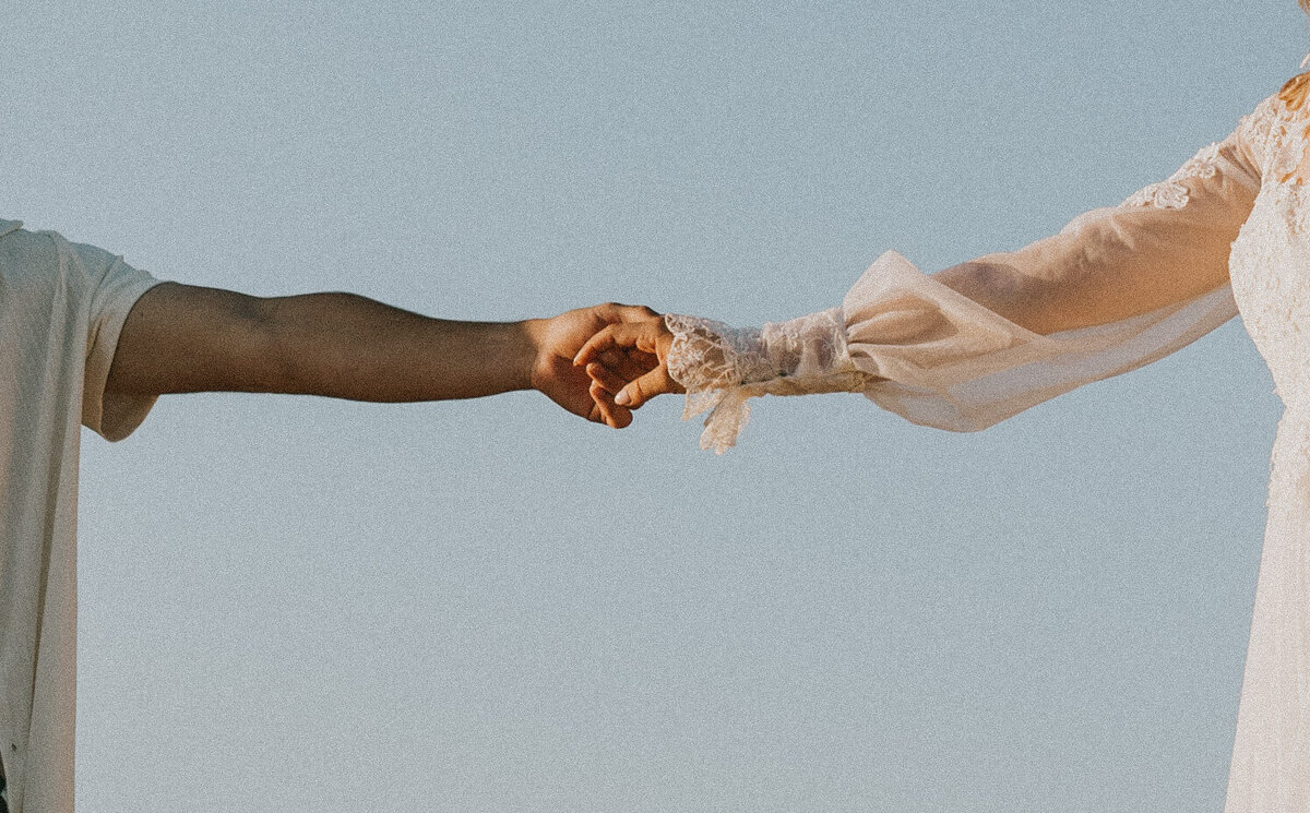 Close-up of couple holding hands, symbolizing connection in Indiana elopement.