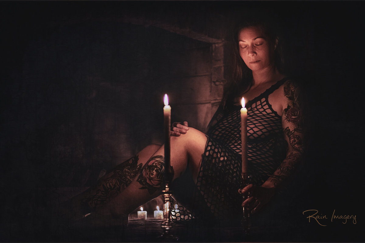 Fine Art Boudoir picture of a woman by a fireplace with candle sticks