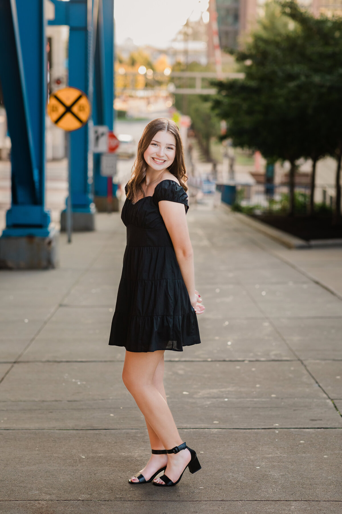 senior girl in black dress posed for senior portraits cleveland senior photographer