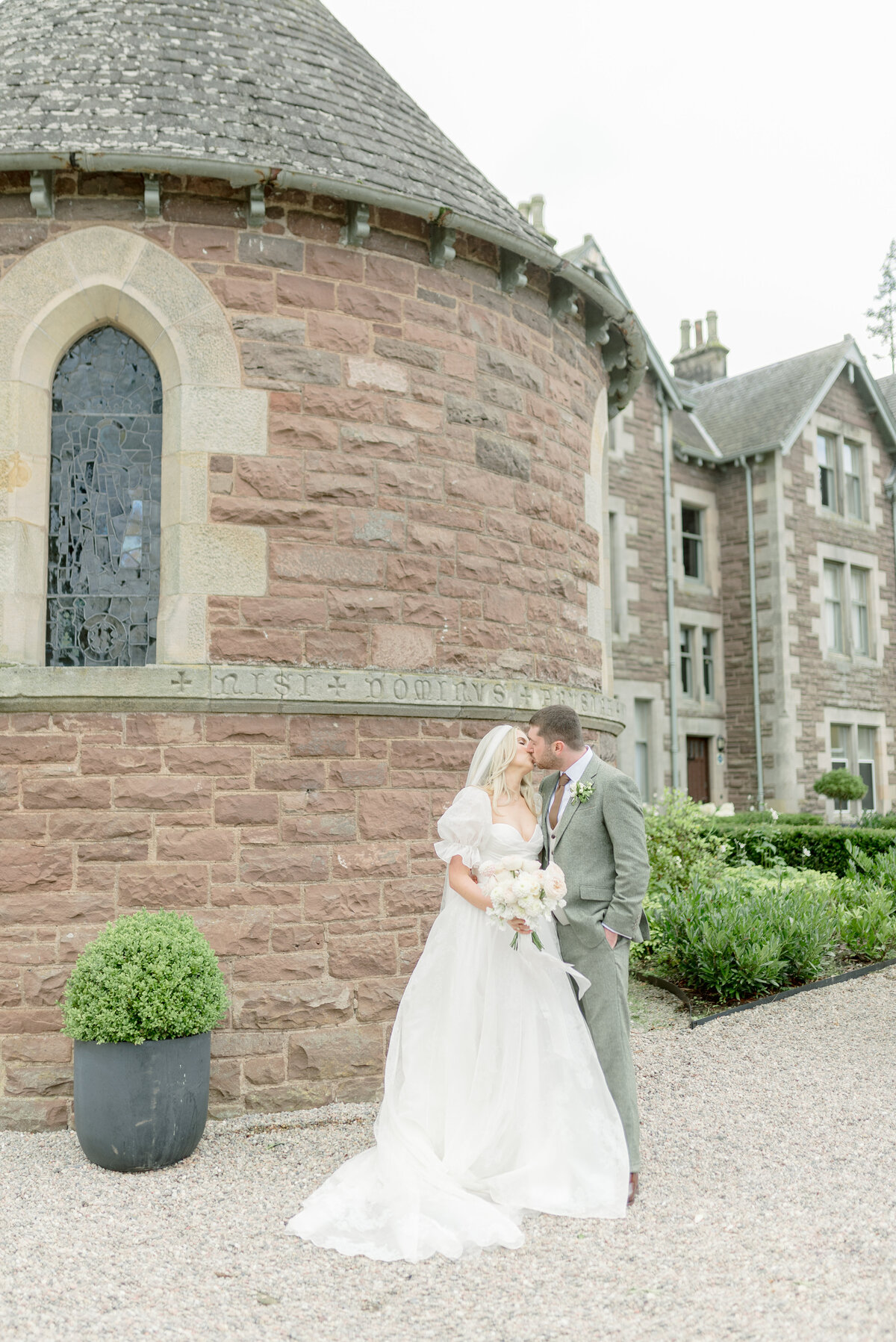 Bride and Groom by the Chapel of Cromlix House, photographed by Scotland fine art wedding photographer.