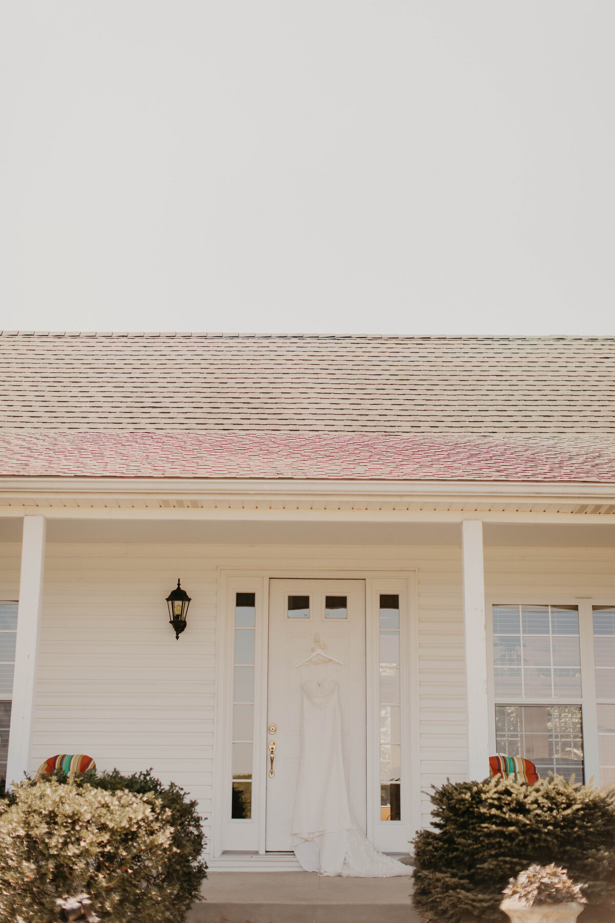 Bridal gown hanging on home. 