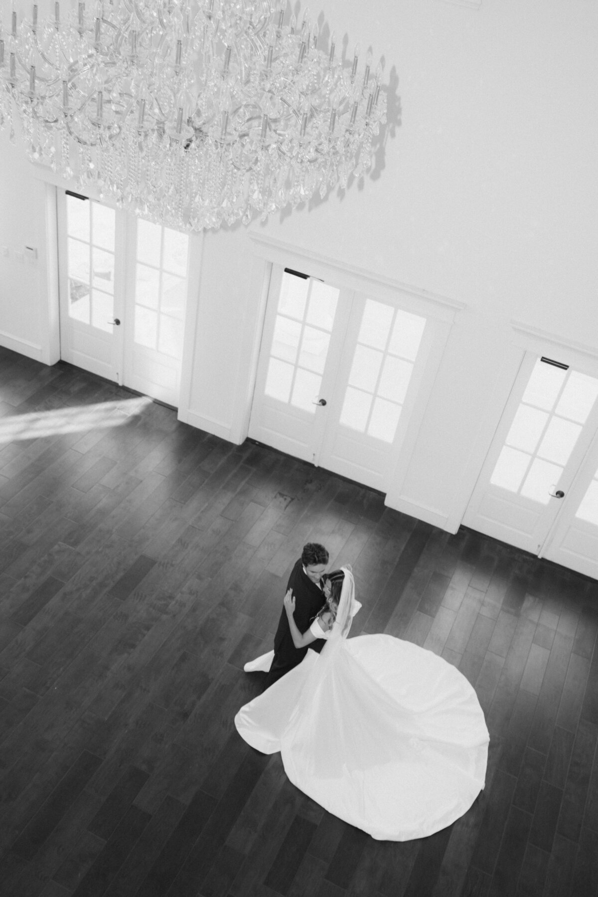 Overhead wide-angle first dance shot under chandelier