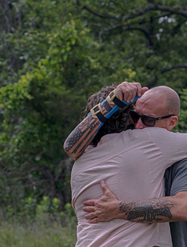 Rising Ridge founder hugging veteran guest of a veteran only retreat.