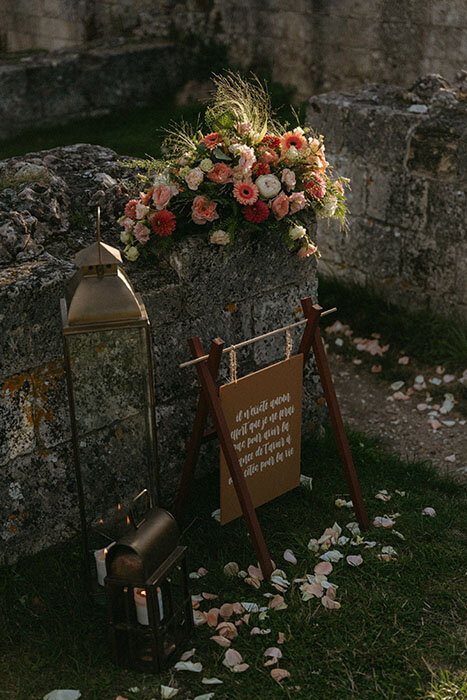 Décor avec composition florale sur de vieilles pierres pour une séance engagement en Normandie.
