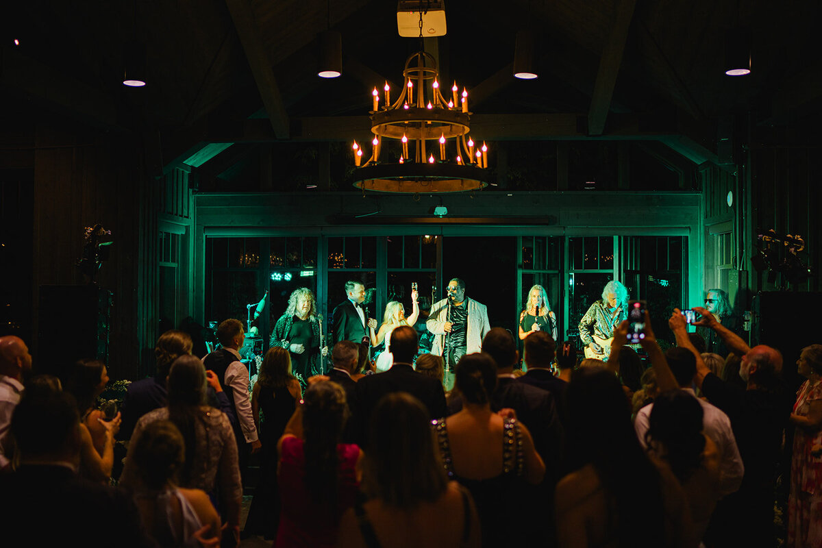 Guests watching a live band perform during an elegant wedding reception in Highlands, North Carolina.