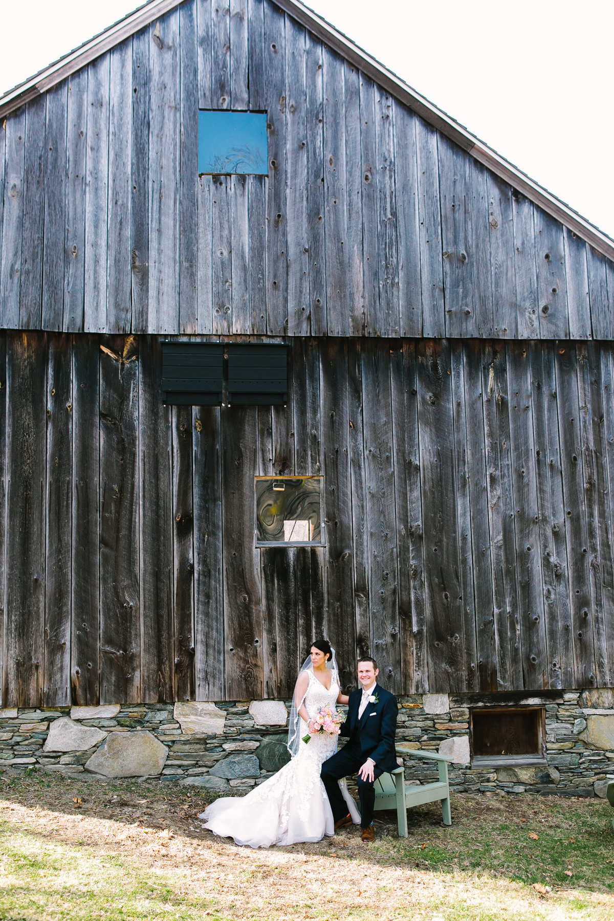bride and groom by the barn