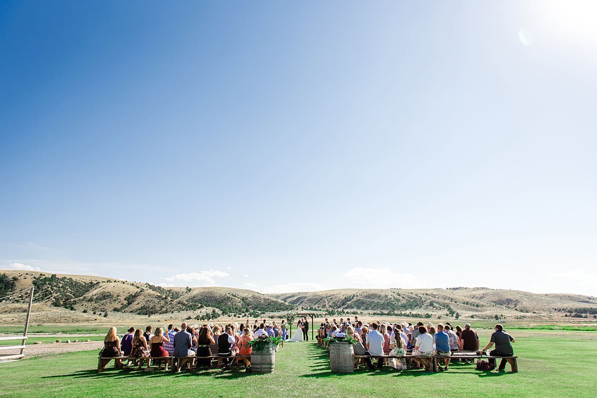 Wide landscape portrait of all wedding guests under the Big Sky Country