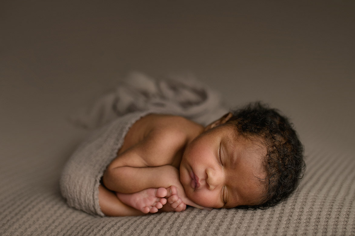 curled up sleeping newborn