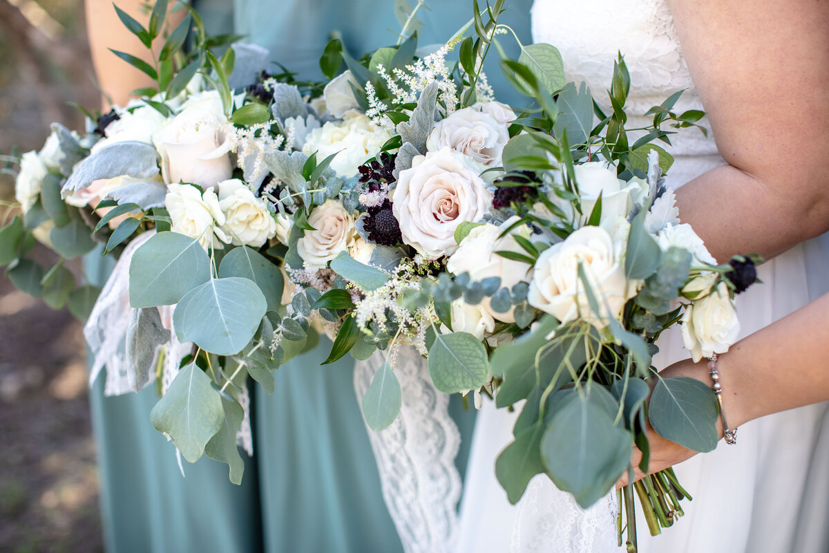 multiple bouquets of sage and white at Morgan Creek Barn wedding in Dripping Springs Texas
