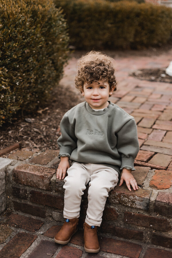 toddler sitting on brick steps