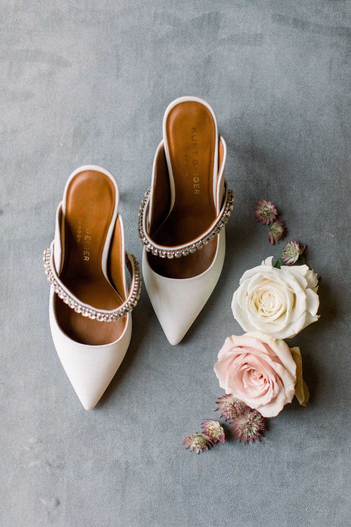 White bridal heel flat lay with roses