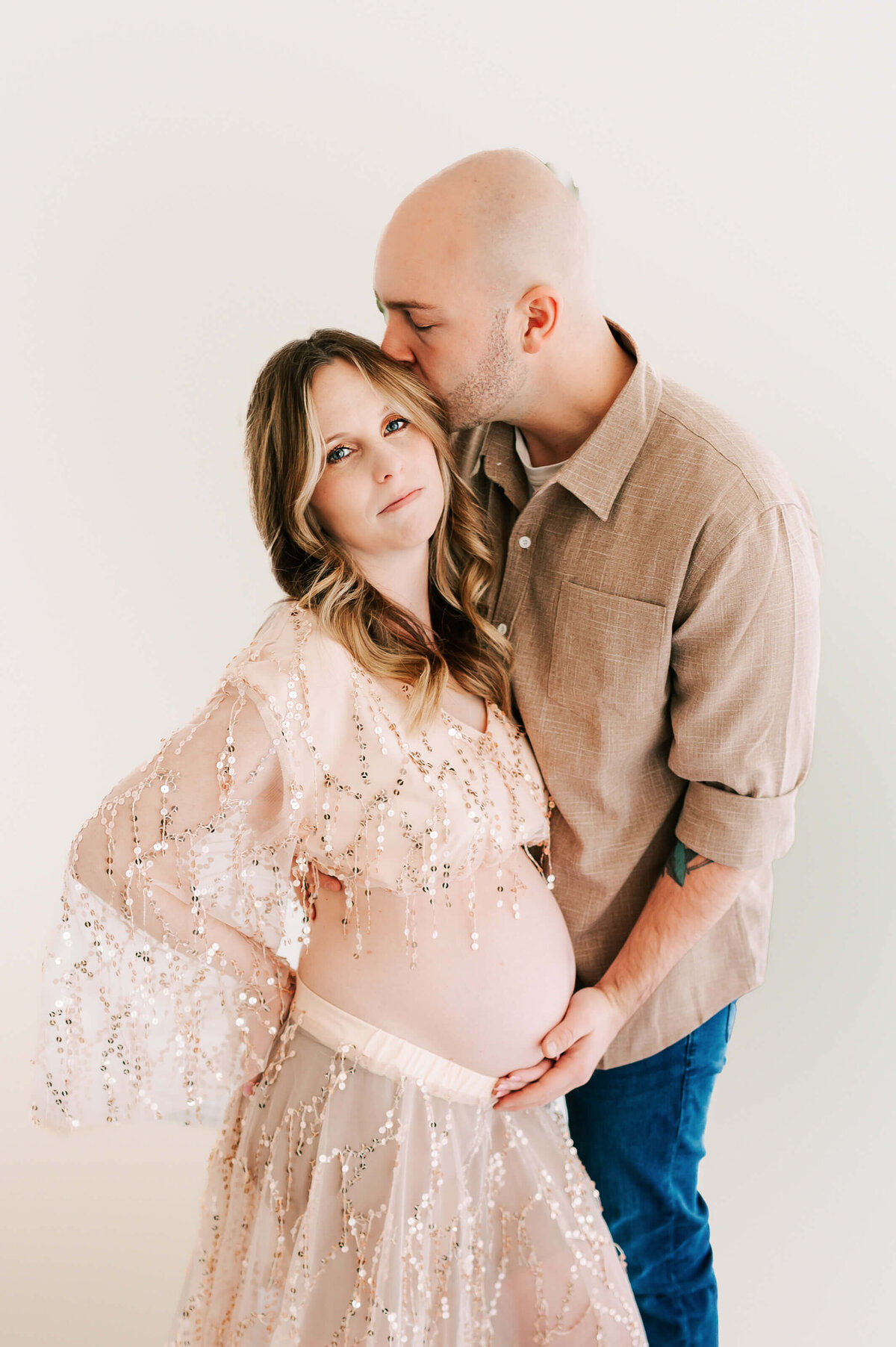 pregnant couple cuddling during maternity photography session in Springfield MO