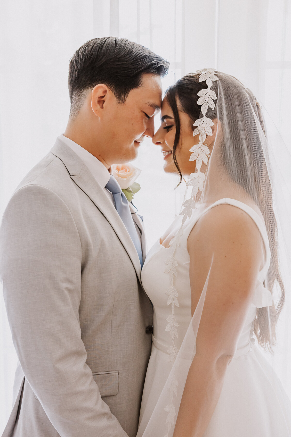 bride and groom backlit by window at terranea resort