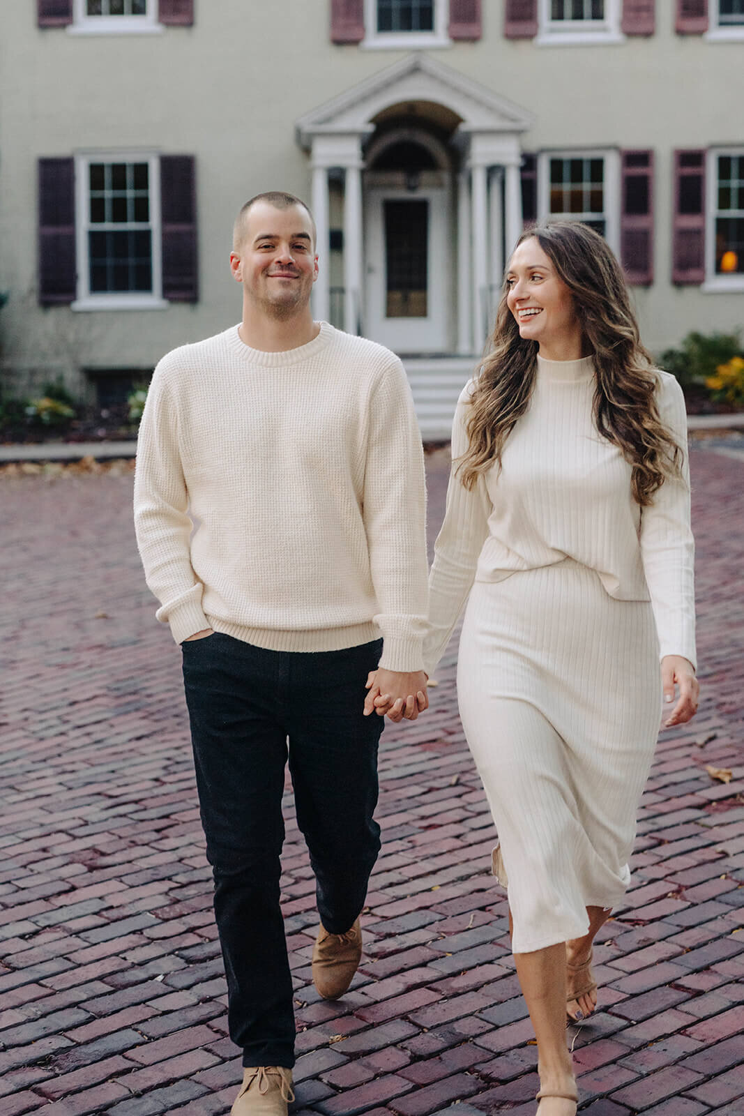 Couple walking along outside a house in Finger Lakes NY